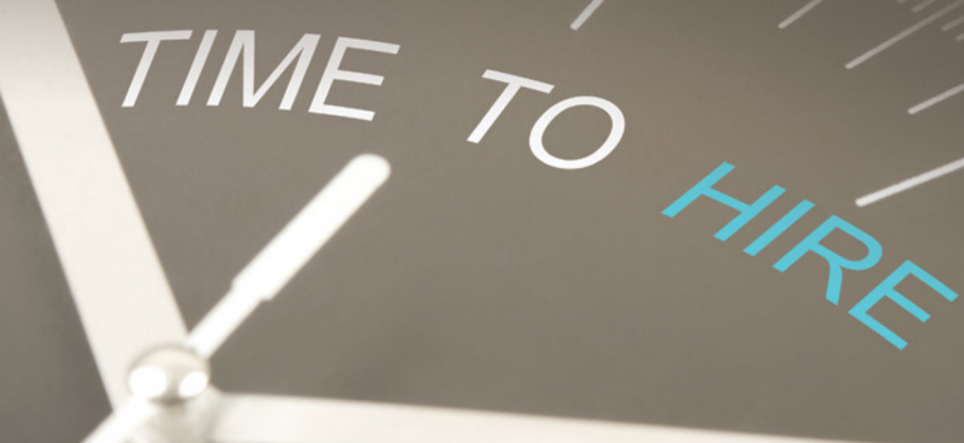 Close-up of clock with hands pointing at "time to hire"